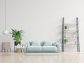 Empty living room with blue sofa  plants and table on empty white wall background Royalty Free Stock Photo