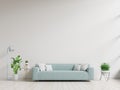 Empty living room with blue sofa, plants and table on empty white wall background Royalty Free Stock Photo