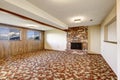 Empty living room with brick fireplace and colorful carpet floor Royalty Free Stock Photo