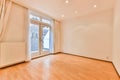 an empty living room with a door to a balcony Royalty Free Stock Photo