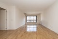 Empty living room with freshly varnished parquet flooring and black aluminum