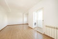 Empty living room of a home with oak laminate flooring with matching skirting boards and doors, enclosed terrace with double pane Royalty Free Stock Photo