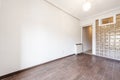 Empty living room of a house with dark brown stoneware floors and a skylight wall with semi-transparent crystal paves