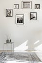 Empty living room interior with coffee table, rug and posters on the floor Royalty Free Stock Photo