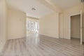 Empty living room with light laminated floors, a bay window with white aluminum and glass windows and walls painted in a smooth Royalty Free Stock Photo