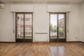 Empty living room with oak wood floor, white painted walls, Royalty Free Stock Photo