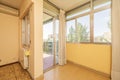 Empty living room with parquet and stoneware flooring, bay window with aluminum window and sliding door leading to a terrace with Royalty Free Stock Photo