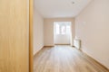 Empty living room with the space of a terrace gained from the room with oak flooring