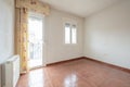 Empty living room with two aluminum windows with triple glazing, red stoneware floors and electric heat accumulator and exit to Royalty Free Stock Photo