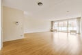 an empty living room with wood floors and a window Royalty Free Stock Photo