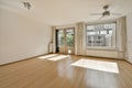 an empty living room with wood floors and a window Royalty Free Stock Photo