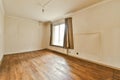 an empty living room with wood floors and a window Royalty Free Stock Photo