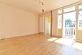 an empty living room with wood floors and a balcony Royalty Free Stock Photo