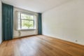 an empty living room with wood floors and a window Royalty Free Stock Photo