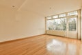 an empty living room with wood floors and a window Royalty Free Stock Photo