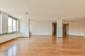 an empty living room with wood floors and a window Royalty Free Stock Photo