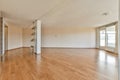 an empty living room with wood floors and a window Royalty Free Stock Photo