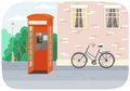 Empty London red classic telephone booth with an open door on the street with a bike at the building Royalty Free Stock Photo