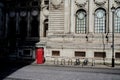 Empty london street scene with red telephone box and longs shadows in winter sun in front of old 19th century building