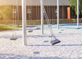 empty lonely swings with sun light in modern park Royalty Free Stock Photo