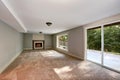 Empty long living room interior with carpet floor and fireplace. Royalty Free Stock Photo