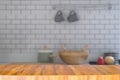 Empty long modern wooden counter on blurred kitchen room