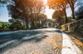 Empty long mountain road to the horizon on a sunny summer day at bright sunset Royalty Free Stock Photo