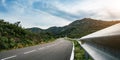 Empty long mountain road to the horizon on a sunny summer day at bright sunset