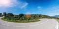 Empty long mountain road to the horizon on a sunny summer day at bright sunset Royalty Free Stock Photo