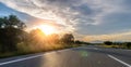 Empty long mountain road to the horizon on a sunny summer day at bright sunset