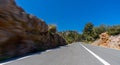 Empty long mountain road to the horizon on a sunny summer day at bright sunset Royalty Free Stock Photo