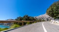 Empty long mountain road to the horizon on a sunny summer day at bright sunset Royalty Free Stock Photo