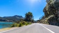 Empty long mountain road to the horizon on a sunny summer day at bright sunset Royalty Free Stock Photo