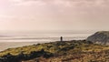 An empty long mountain road to the horizon on a sunny summer day at a bright sunset. Silhouettes of couples against the