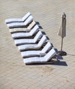 Empty lounge chairs in a row Royalty Free Stock Photo