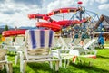 Empty lounger and water slide in aquapark