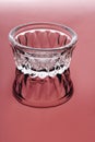 Empty low glass cup on a red background. Royalty Free Stock Photo