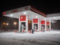 An empty Lukoil gas station on a winter night during heavy snowfall. Royalty Free Stock Photo