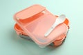 Empty lunch box with spoon on light blue background Royalty Free Stock Photo