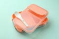 Empty lunch box with spoon on light blue background Royalty Free Stock Photo