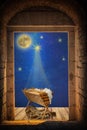 Empty manger under night sky and moon