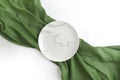 Empty marble plate with green fabric on white textured background. Royalty Free Stock Photo