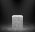 Empty marble podium on concrete floor with spotlight background. 3D rendering.