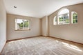 Empty master bedroom with window and high vaulted ceiling