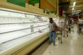 Empty meat display shelves at a Publix grocery store due to the people panicking and hoarding paper and food products