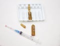 Empty medical ampoules infusion and used syringe after injection on white background Royalty Free Stock Photo