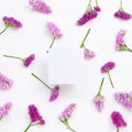 Empty memo paper with pink purple statice flowers on white background