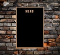 Empty menu board hanging on grunge brick wall Royalty Free Stock Photo