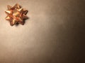 Empty message area with ornament as bright star, note paper or frame on dark and light brown background.