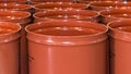 Empty metal barrels for storage and transportation of orange juice in the warehouse of canning orange factory or plant